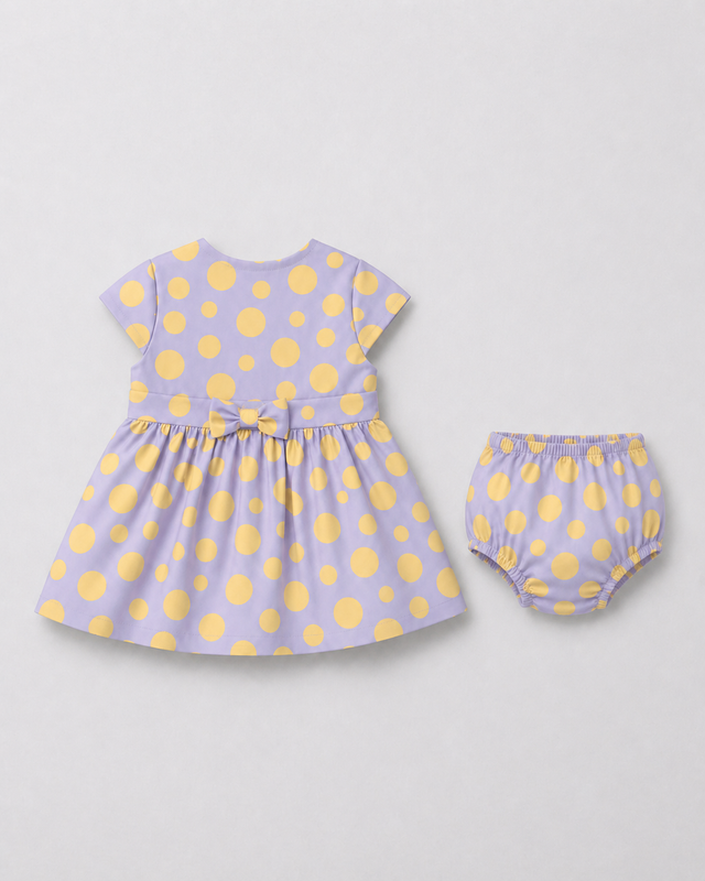 Baby wearing Anaario Lavender Dot Bow lavender with soft yellow polka dots dress set, newborn to 24 months