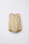 Baby wearing Anaario Lavender Yellow Polka Dot Button sleeveless romper, newborn to 24 months