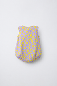 Baby wearing Anaario Lavender Yellow Polka Dot Button sleeveless romper, newborn to 24 months