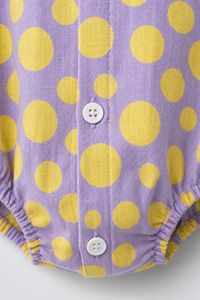 Baby wearing Anaario Lavender Yellow Polka Dot Button sleeveless romper, newborn to 24 months