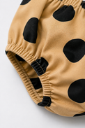 Baby wearing Anaario Mocha Dot Frill mocha base with black polka dots dress set, newborn to 24 months