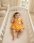 Baby wearing Anaario Orange Polka Bow orange with white polka dots dress set, newborn to 24 months