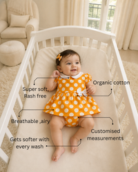 Baby wearing Anaario Orange Polka Bow orange with white polka dots dress set, newborn to 24 months