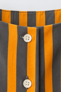 Baby wearing Anaario Orange Taupe Stripe Frill orange and taupe vertical stripes dress set, newborn to 24 months