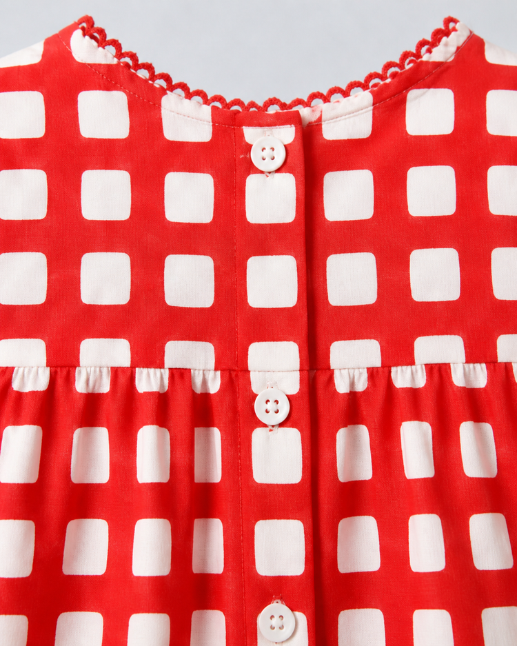 Baby wearing Anaario Cherry Check Bubble red and white gingham puff sleeve romper, newborn to 24 months