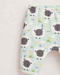 Baby wearing Anaario Sheep and Nightsky organic cotton pyjama set, newborn to 24 months