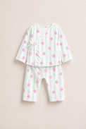 Baby wearing Anaario Strawberry Wrap white with pink strawberry prints and mint stripes co-ord set, newborn to 24 months