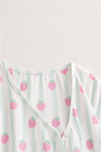 Baby wearing Anaario Strawberry Wrap white with pink strawberry prints and mint stripes co-ord set, newborn to 24 months