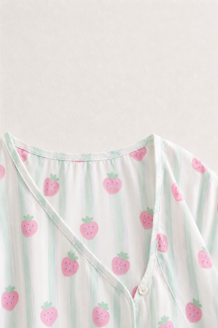 Baby wearing Anaario Strawberry Wrap white with pink strawberry prints and mint stripes co-ord set, newborn to 24 months