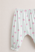 Baby wearing Anaario Strawberry Wrap white with pink strawberry prints and mint stripes co-ord set, newborn to 24 months