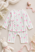 Baby wearing Anaario Strawberry Wrap white with pink strawberry prints and mint stripes co-ord set, newborn to 24 months