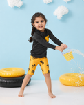 Boy wearing Anaario Black and Mustard Horse Swim Set