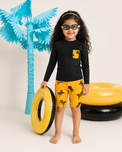 Boy wearing Anaario Black and Mustard Horse Swim Set