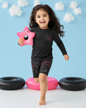 Boy wearing Anaario Black and Neon Swirl Swim Set