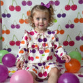 Girl wearing Anaario Cherry Jubilee Ruffle Dress