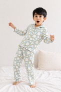 Boy wearing Anaario Ivory and Tangerine Poppy Raindrops Night Suit