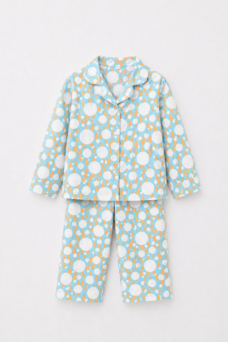 Boy wearing Anaario Ivory and Tangerine Poppy Raindrops Night Suit