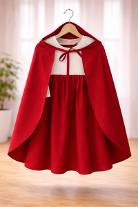 Girl wearing Anaario Little Red Riding Hood Dress, red hooded cape over white and red dress