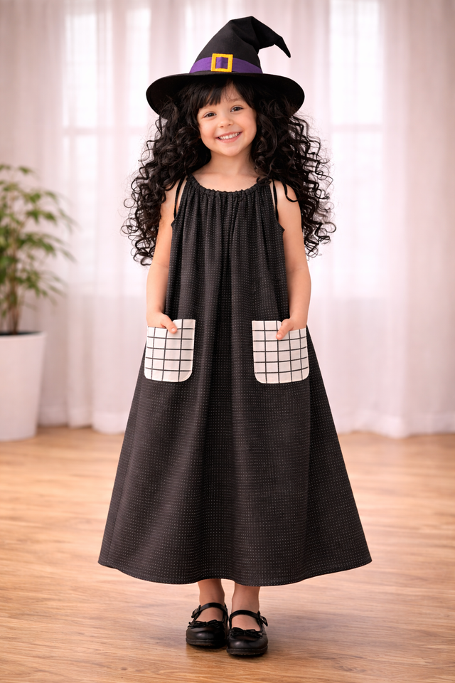 Girl wearing Anaario Midnight Spell Witch Gown, black gown with grid-print pockets and witch hat