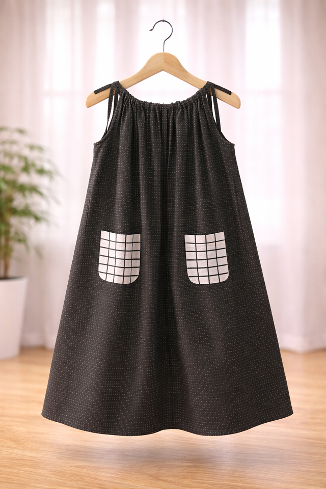 Girl wearing Anaario Midnight Spell Witch Gown, black gown with grid-print pockets and witch hat