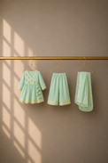 Anaario Mint Green Flamingo Angrakha Set, mint green angrakha top, pants and dupatta on hangers
