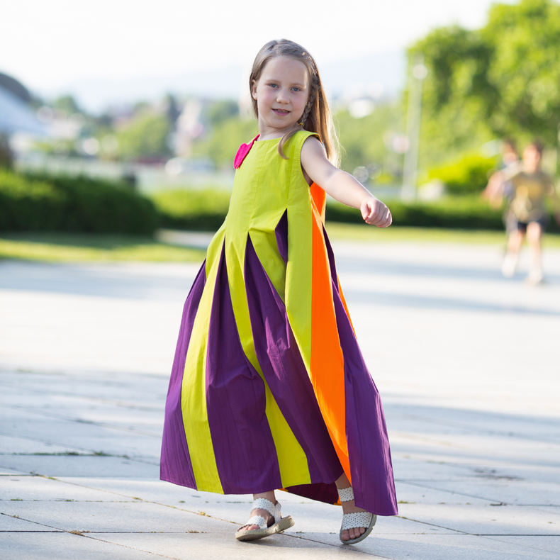 Girl wearing Anaario Pixie Dixie colorblock maxi dress in lime green, purple, and orange