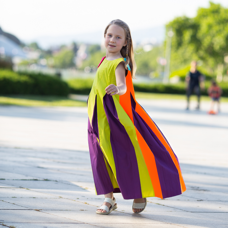 Girl wearing Anaario Pixie Dixie colorblock maxi dress in lime green, purple, and orange