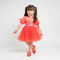 Girl wearing Anaario Coral Blossom Princess Dress, coral puff-sleeve tulle dress with beaded bodice