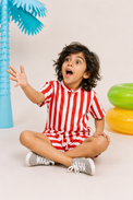 Boy wearing Anaario Red Stripe Shirt, red and white striped shirt, shown styled with matching shorts