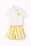 Boy wearing Anaario Sunwave Pocket Shirt Set, white pocket shirt with matching yellow wavy-striped shorts
