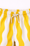 Boy wearing Anaario Sunwave Pocket Shirt Set, white pocket shirt with matching yellow wavy-striped shorts
