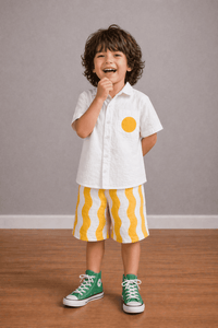 Boy wearing Anaario Sunwave Pocket Shirt Set, white pocket shirt with matching yellow wavy-striped shorts