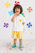 Boy wearing Anaario Sunwave Pocket Shirt Set, white pocket shirt with matching yellow wavy-striped shorts