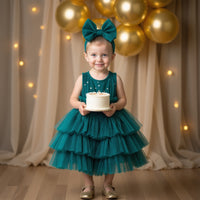 Girl wearing Anaario Emerald Tiered Tiara Dress, emerald green tiered tulle dress with beaded bodice