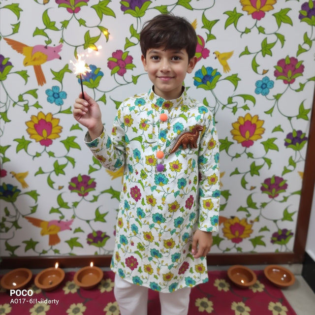 Boy wearing Anaario Garden Kurta Set, white kurta with multicolor floral garden print and dinosaur toy-pocket applique