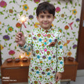 Boy wearing Anaario Garden Kurta Set, white kurta with multicolor floral garden print and dinosaur toy-pocket applique