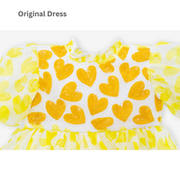 Girl wearing Anaario yellow organza party dress with hearts motif