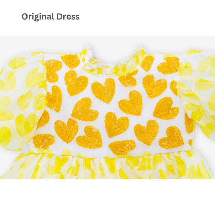 Girl wearing Anaario yellow organza party dress with hearts motif