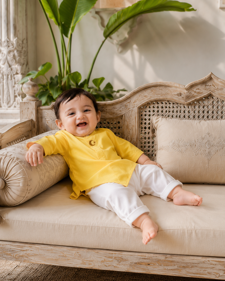 Baby wearing Anaario Yellow Moon-Star Baby Kurta Set, yellow kurta with moon-and-star embroidered jacket, newborn to 24 months