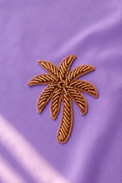 Palm-tree embroidered motif, close-up detail