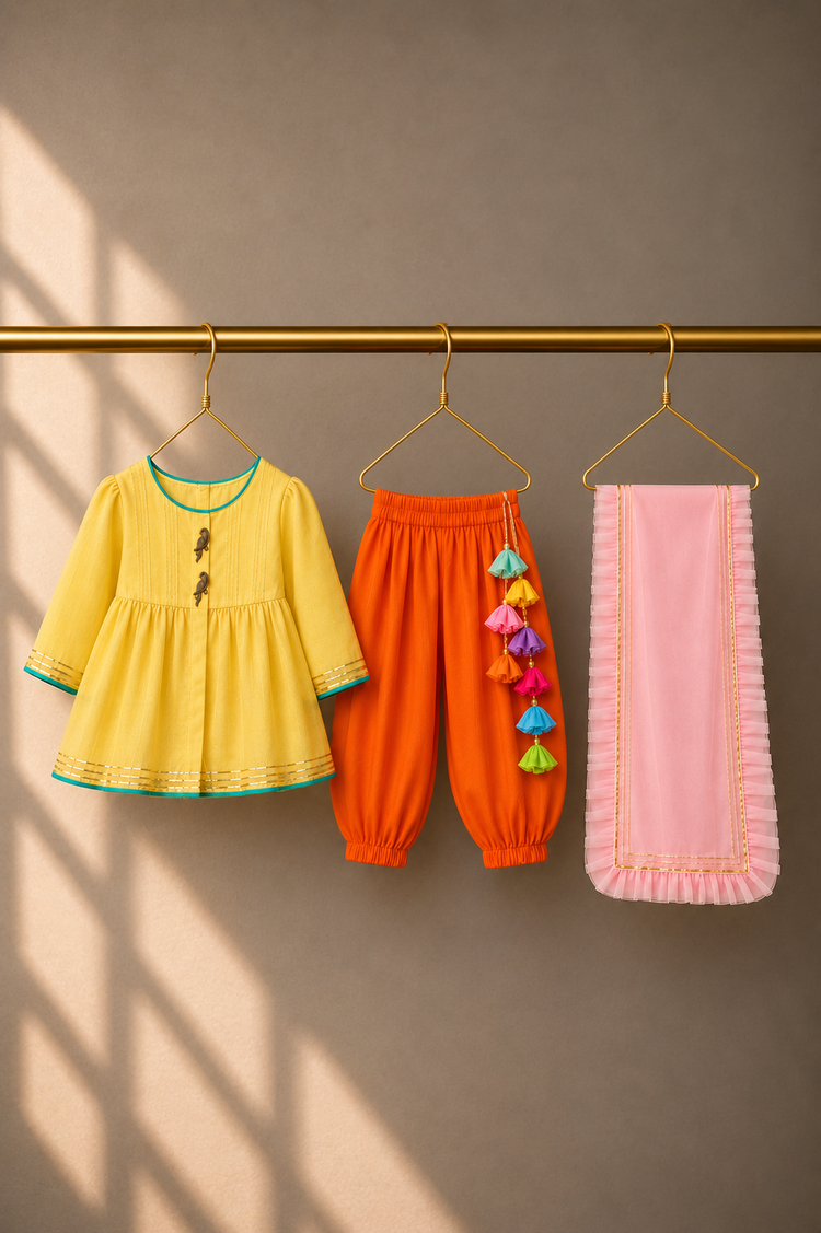 Anaario Yellow Parrot Patiala Salwar Set, yellow kurta, orange salwar and pink dupatta on hangers