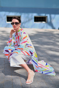 Person wearing Anaario Candy Fever Co-ord Set, white maxi duster with multicolor brushstroke print over matching pants