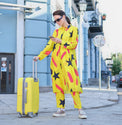 Person wearing Anaario Casablanca Co-ord Set, yellow duster with black star and coral brushstroke print over matching pants