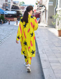 Person wearing Anaario Casablanca Co-ord Set, yellow duster with black star and coral brushstroke print over matching pants