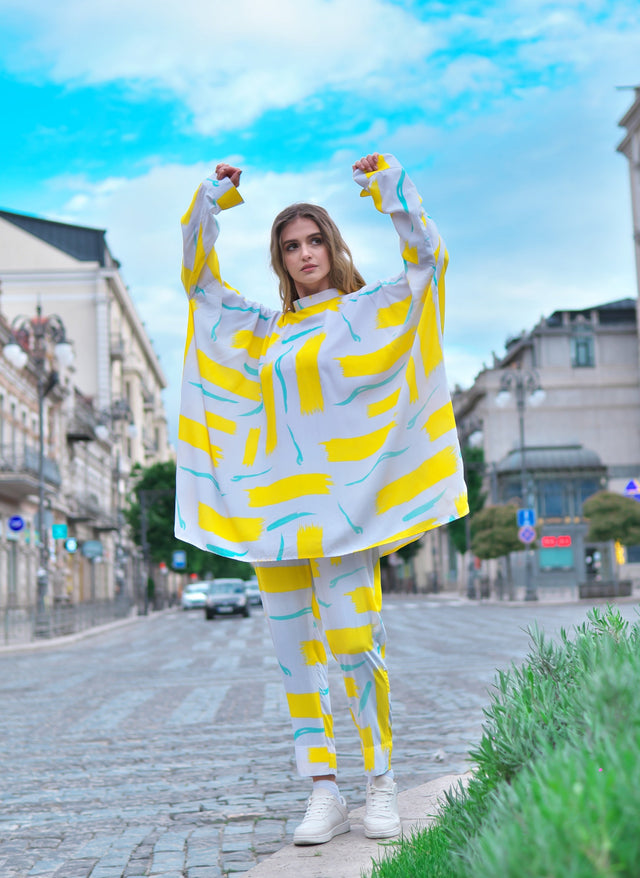 Person wearing Anaario City Girl Co-ord Set, white and yellow abstract print oversized top and matching pants