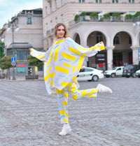 Person wearing Anaario City Girl Co-ord Set, white and yellow abstract print oversized top and matching pants