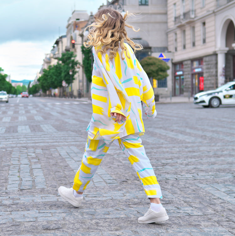 Person wearing Anaario City Girl Co-ord Set, white and yellow abstract print oversized top and matching pants