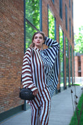 Person wearing Anaario City Girl Co-ord Set, mixed burgundy and navy stripe shirt and matching pants