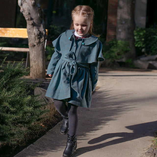 Girl wearing Anaario Diana Capelet Coat, teal wool-look coat with cape collar and tie waist