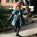 Girl wearing Anaario Diana Capelet Coat, teal wool-look coat with cape collar and tie waist